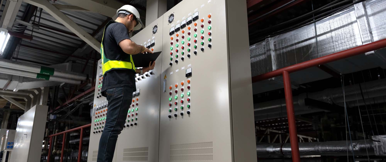 Electrical Engineer team working front HVAC control panels,